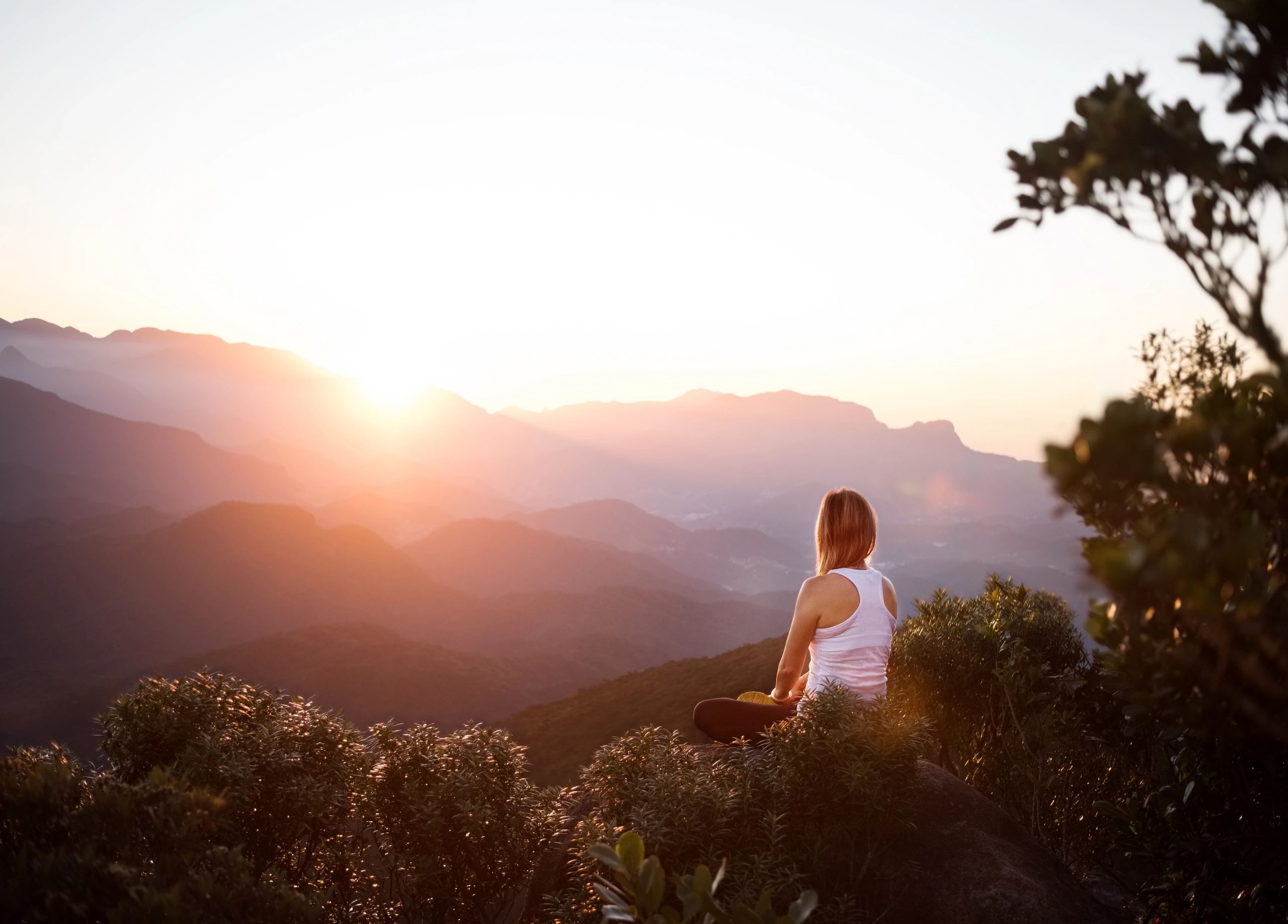 Person watching sunrise from a mountain viewpoint