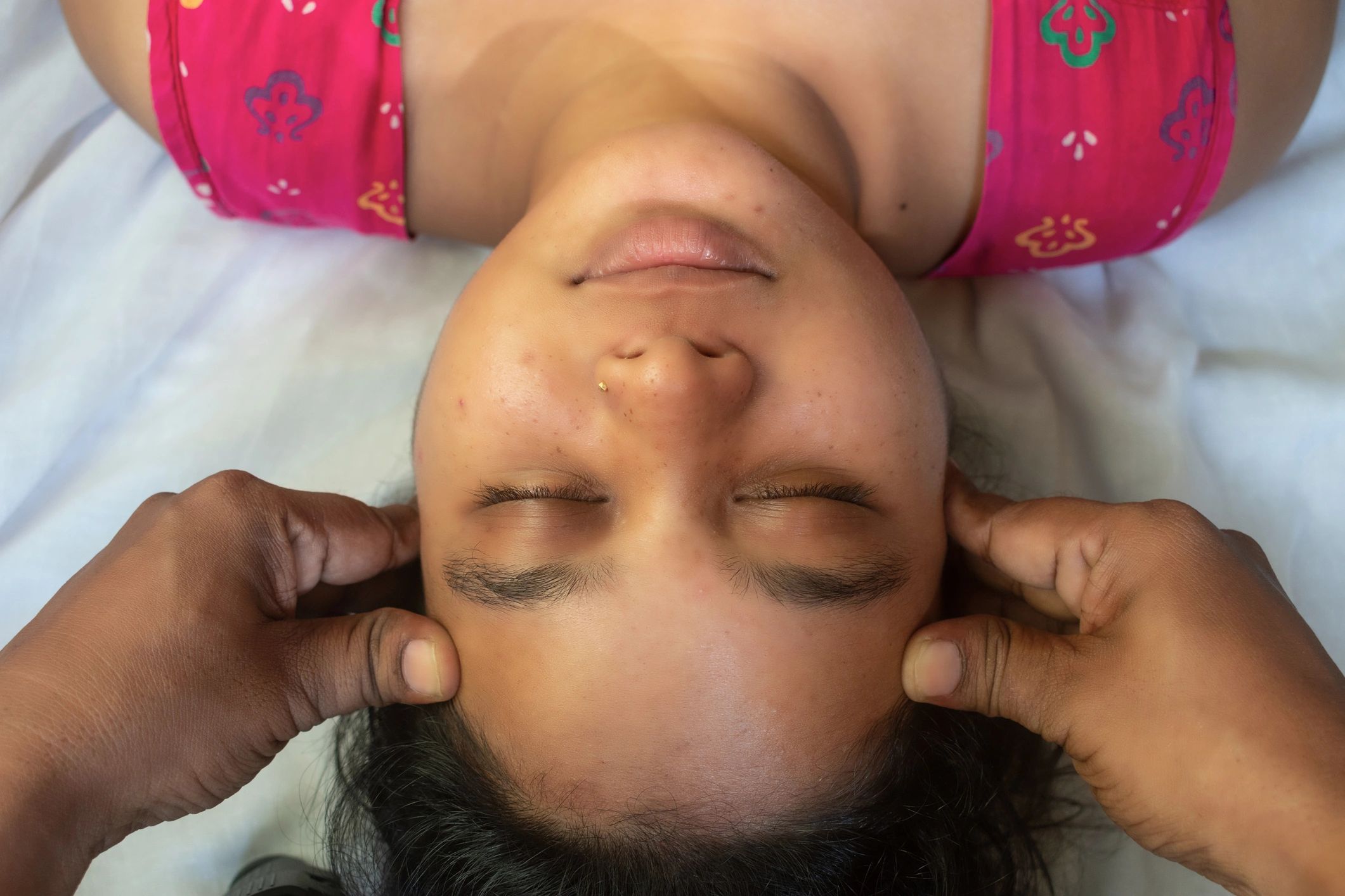 Guest receiving a relaxing head and face massage