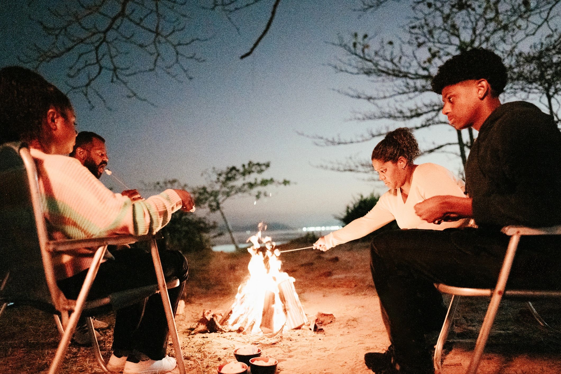 People gathered around a campfire at night