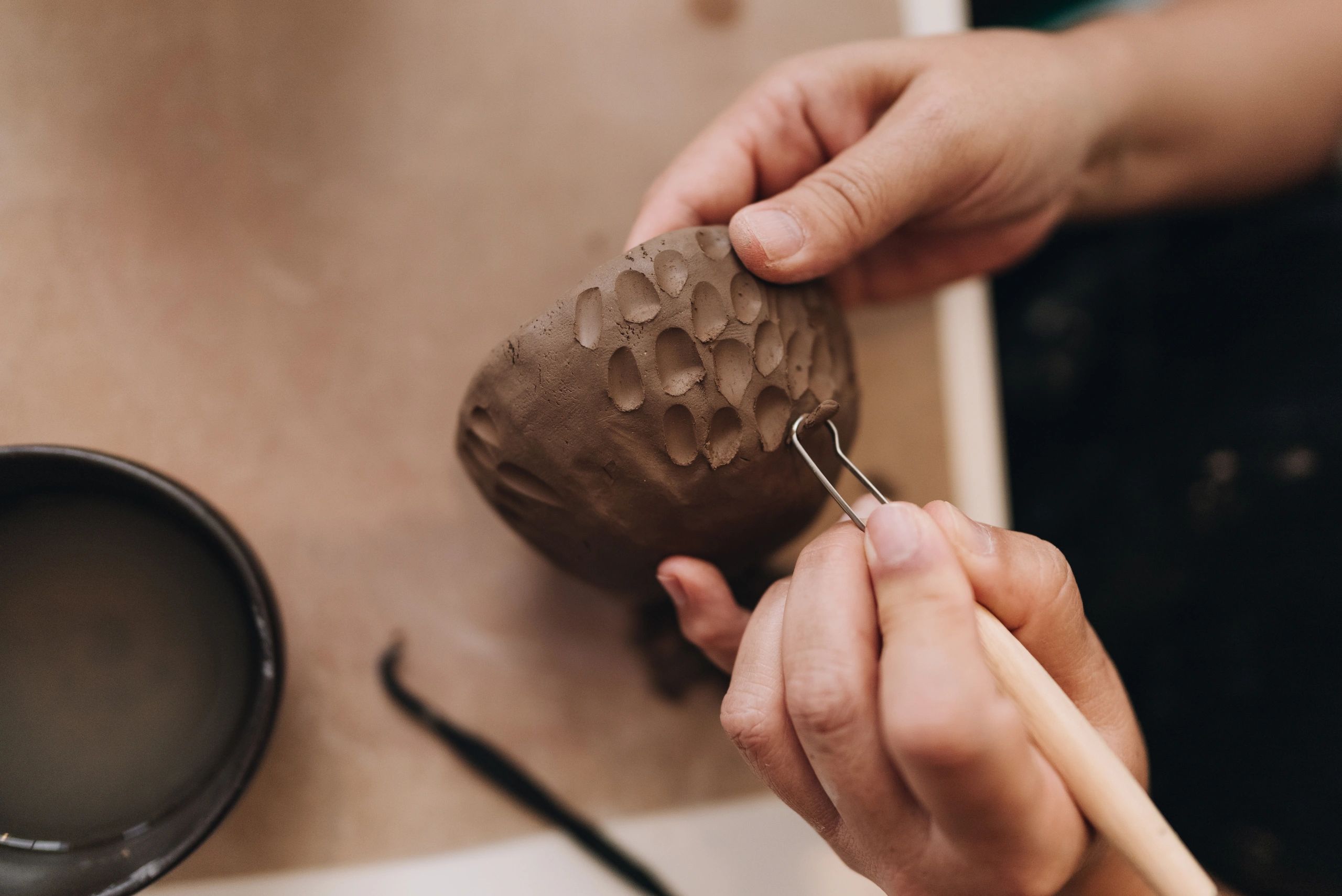 Close-up of a person working with ceramic clay