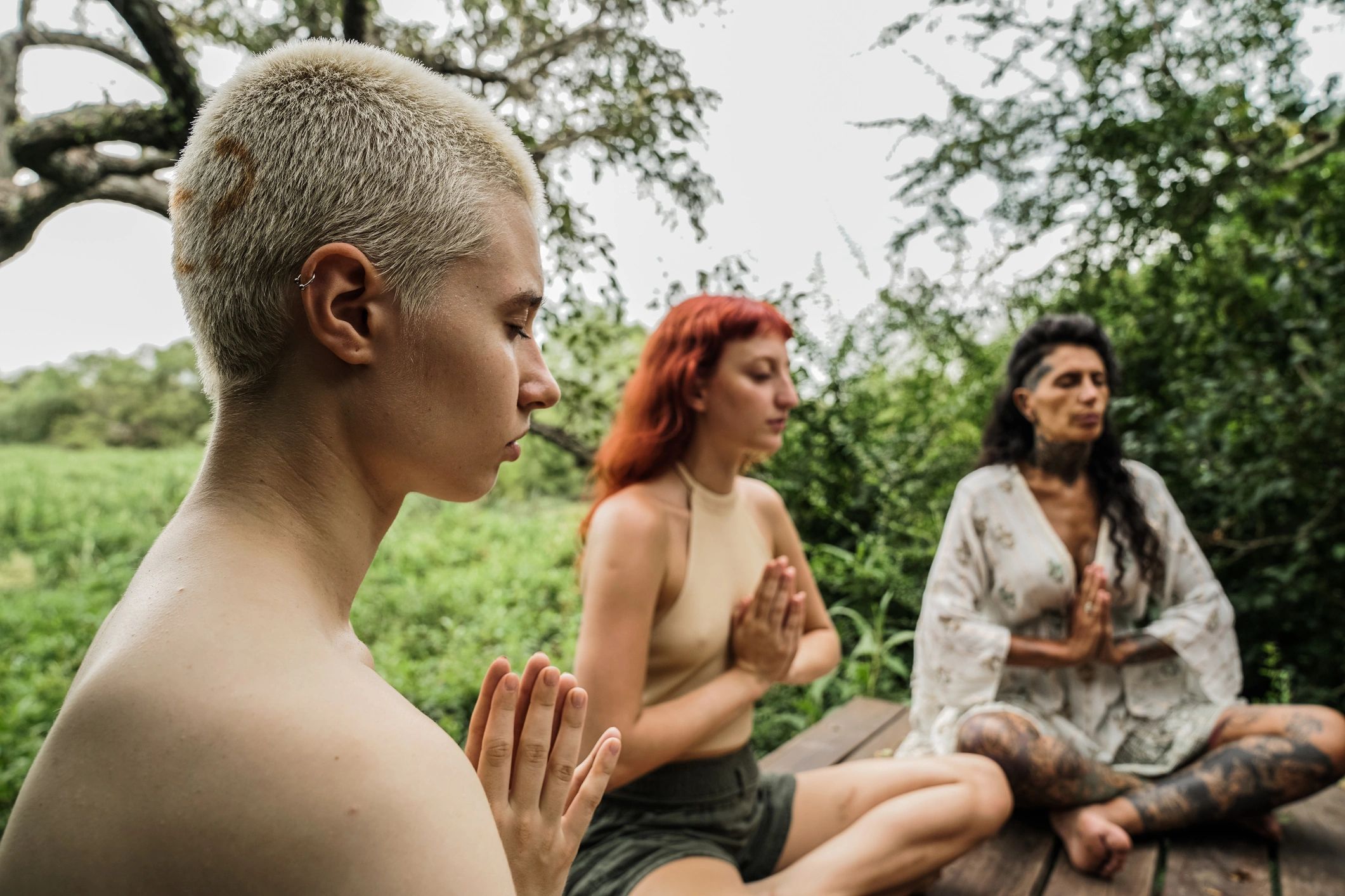 Group practicing yoga outdoors in nature