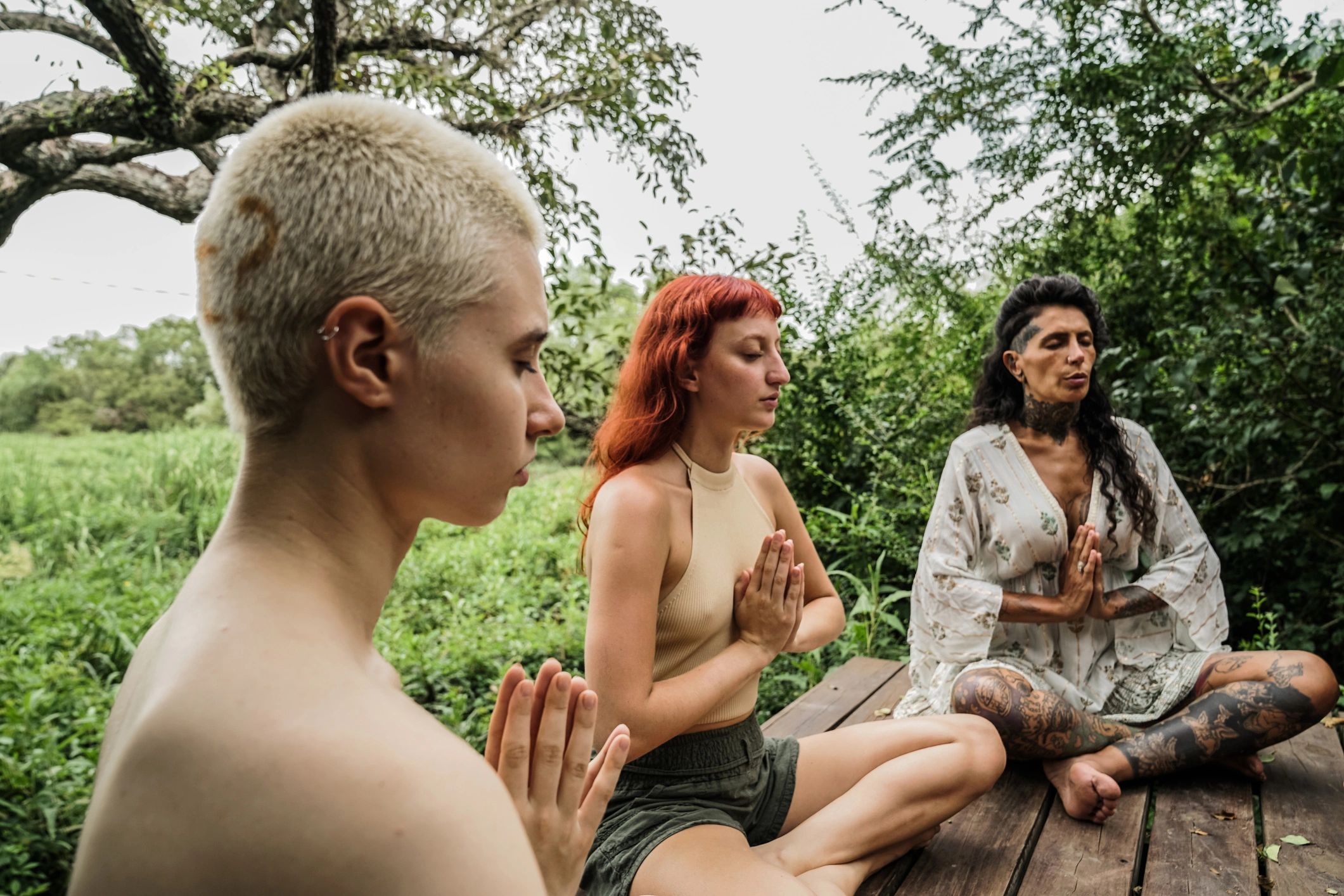 Group practicing yoga outdoors in nature