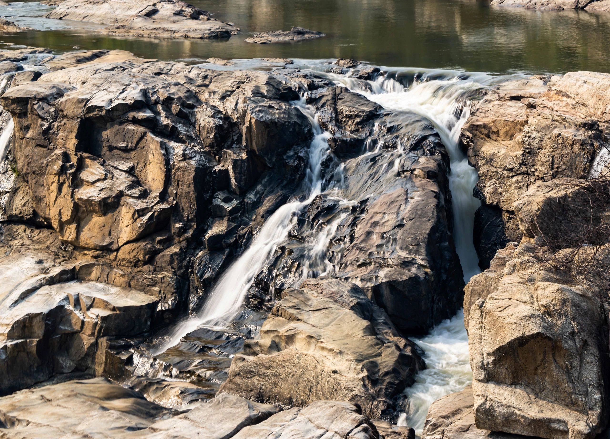 Long exposure waterfall in a forested landscape