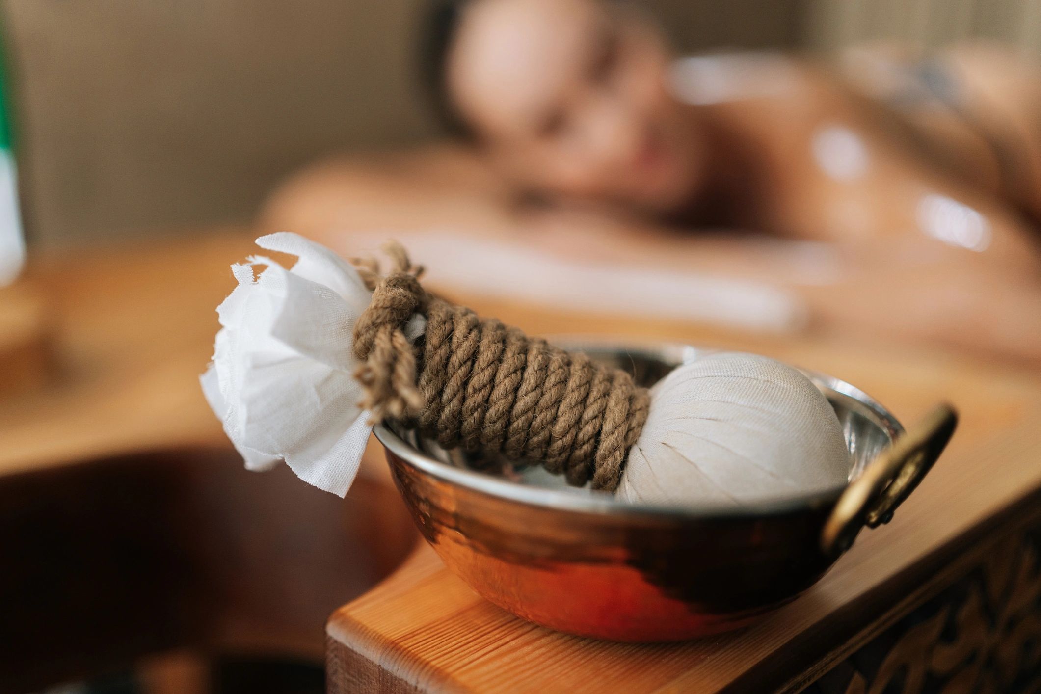 Ayurvedic wellness treatment setting with herbal massage pads