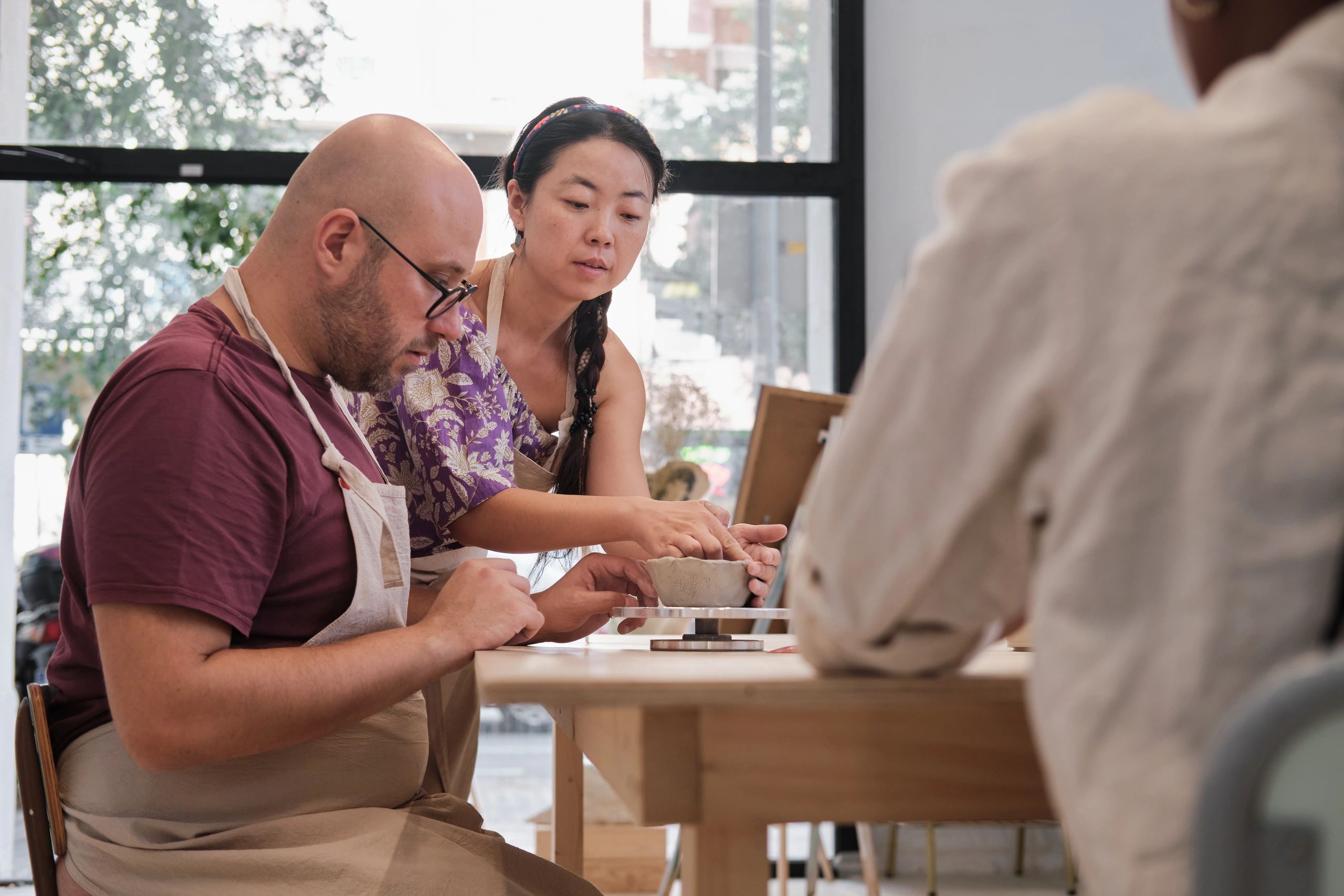 People learning pottery in a workshop
