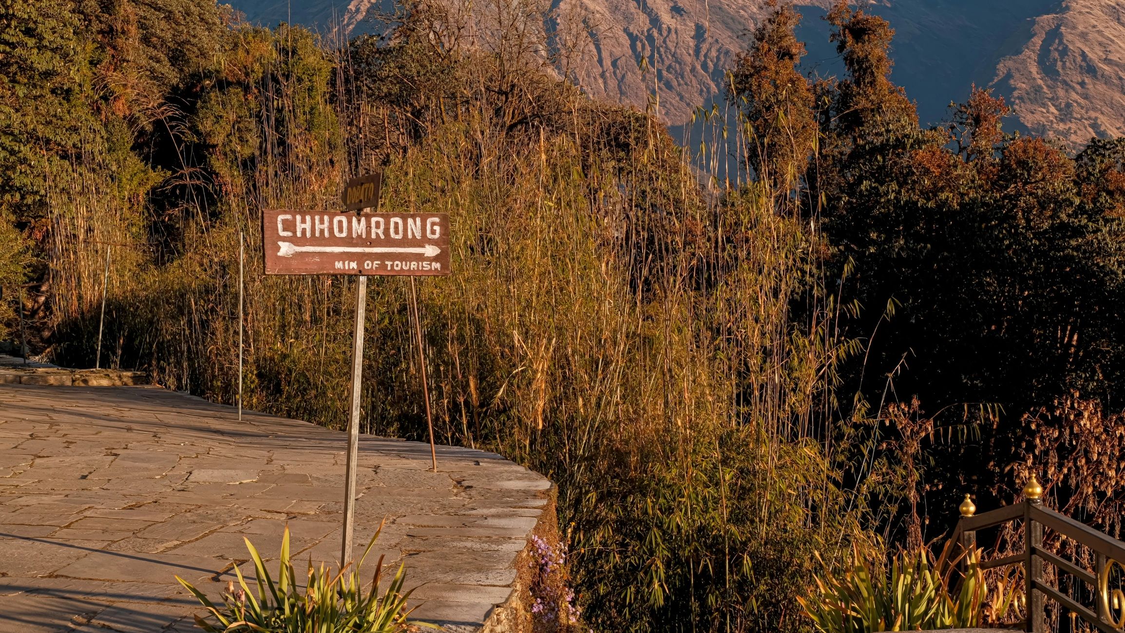 Mountain trail sign and morning light in the Himalayas