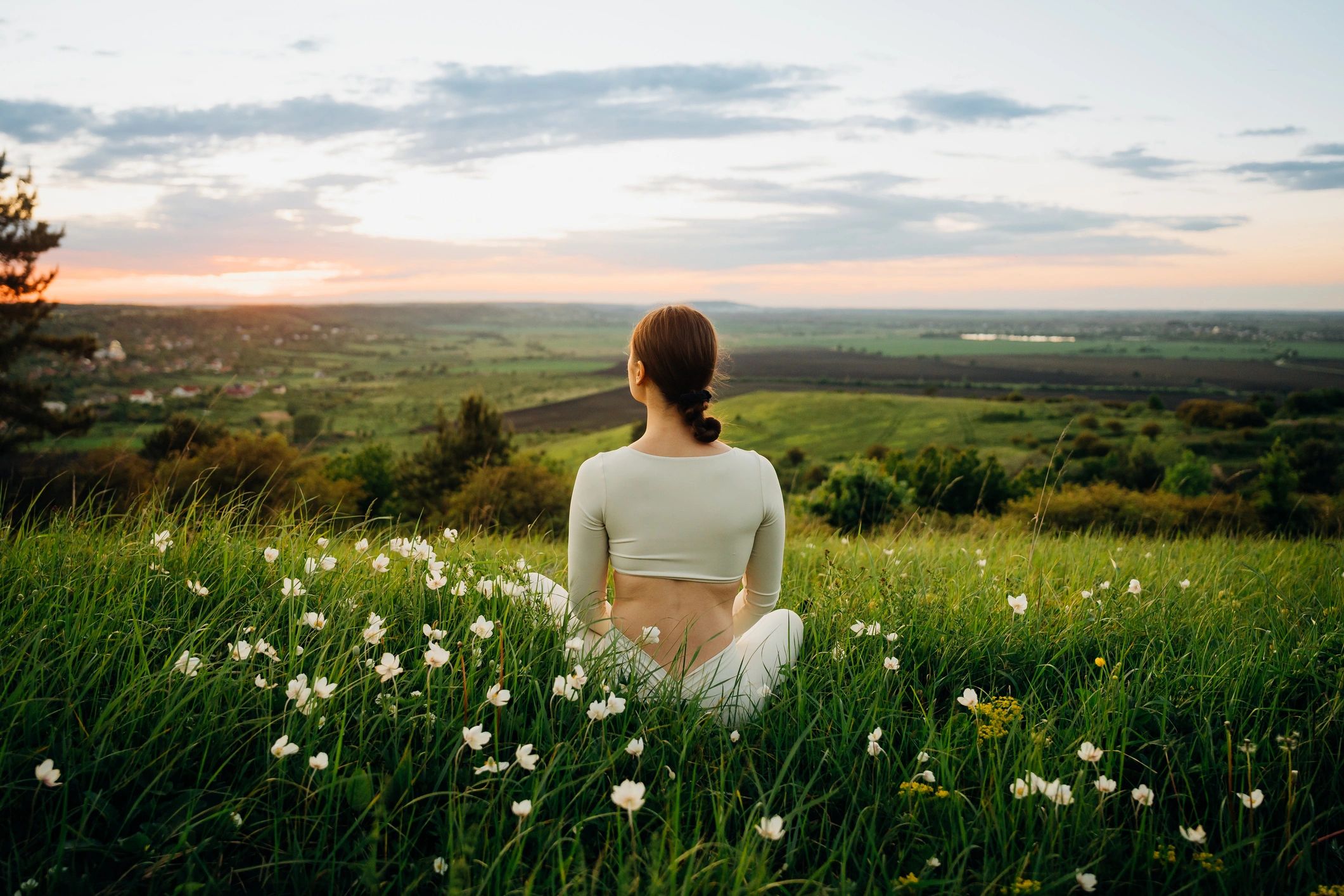 Meditation in a meadow at sunrise