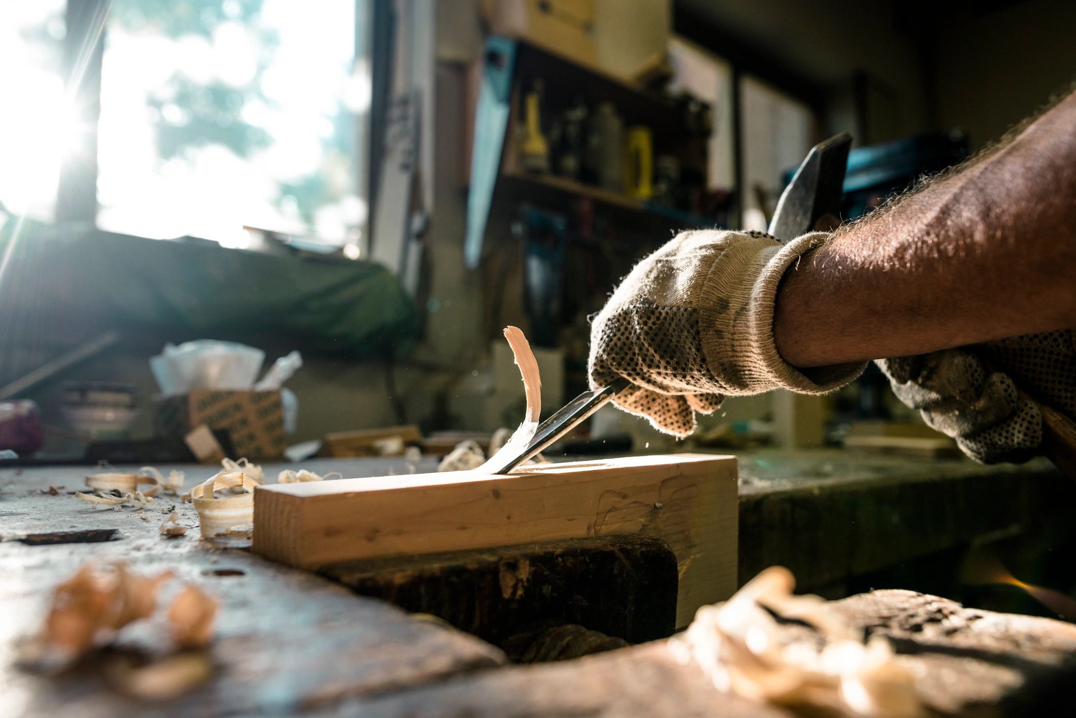 Carpenter shaping wood with a chisel
